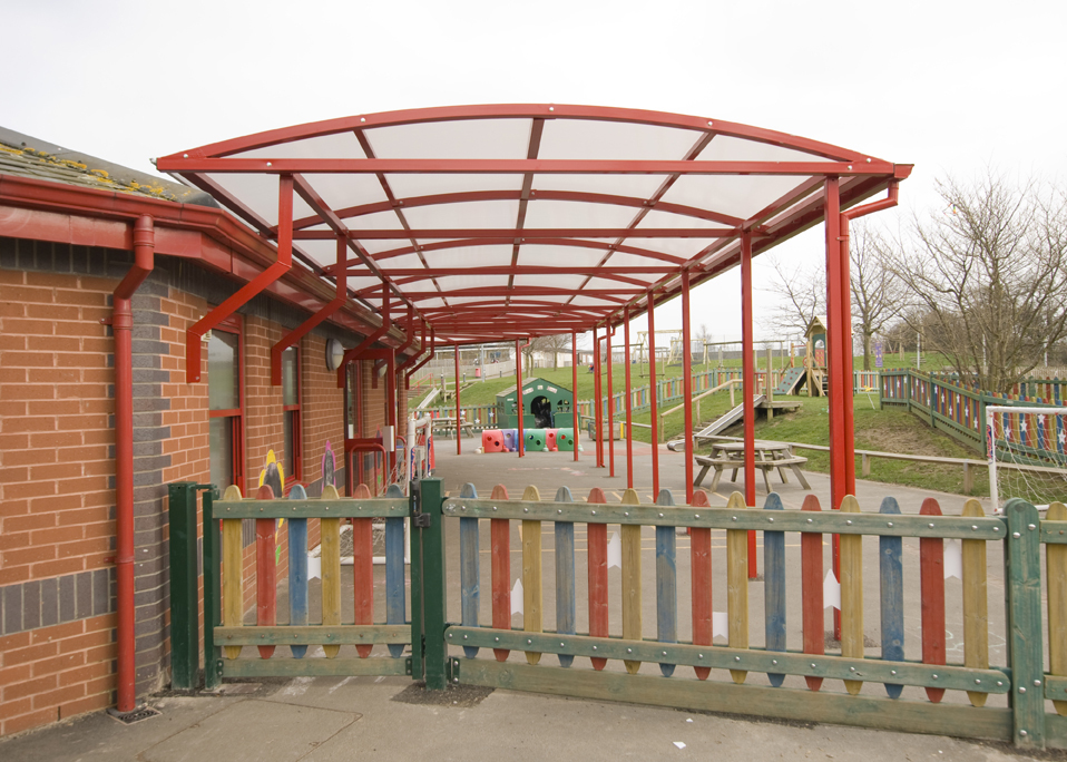 Image of a red shelter store walkway canopy installed at a school